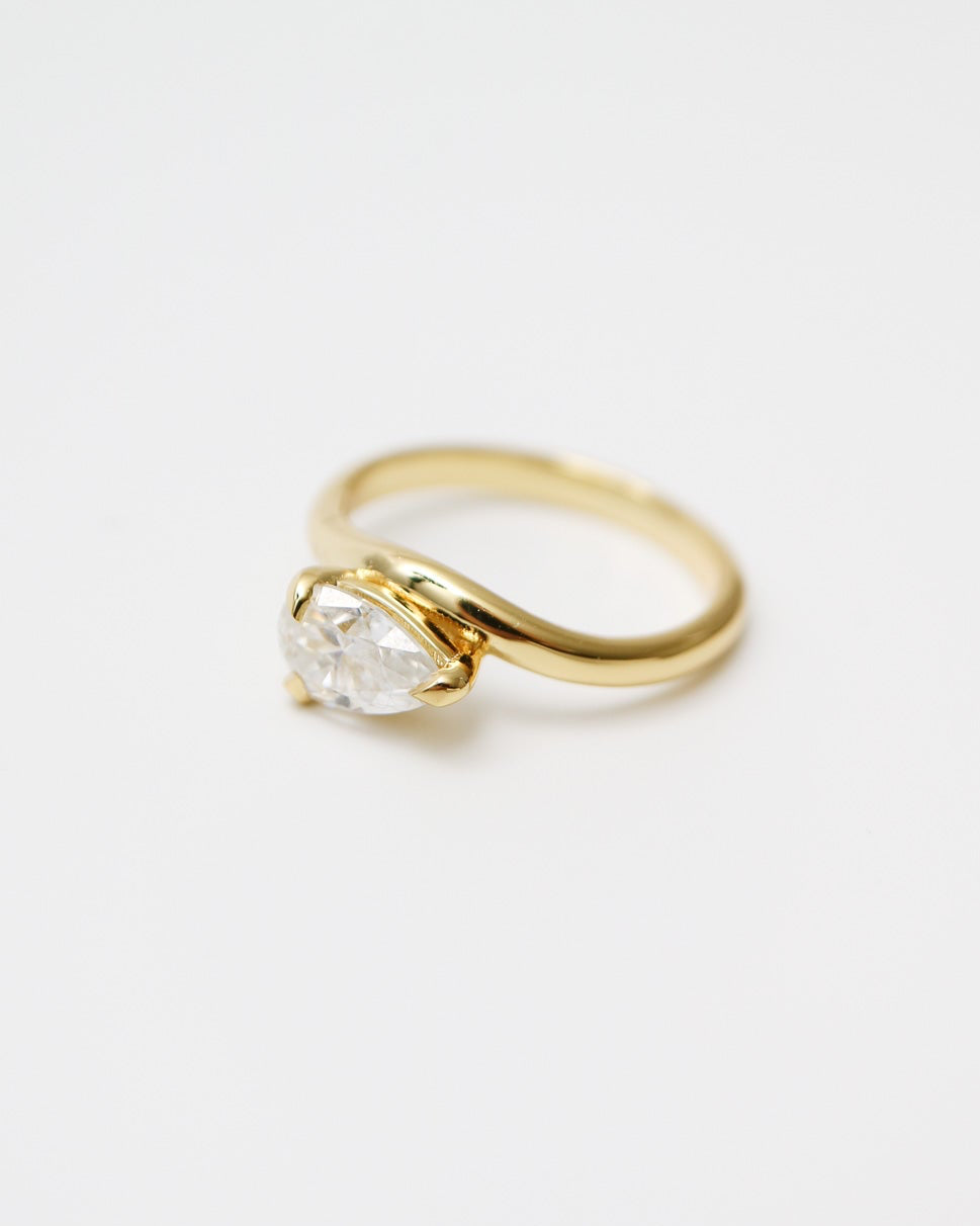 Gold ring with a diamond on a white background