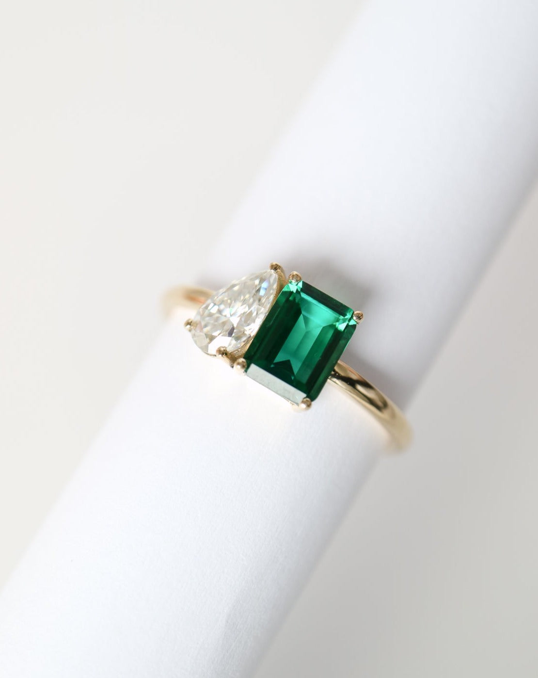 9kt gold Venus Ring with pear moissanite and emerald baguette from Theia Jewellery engagement rings
