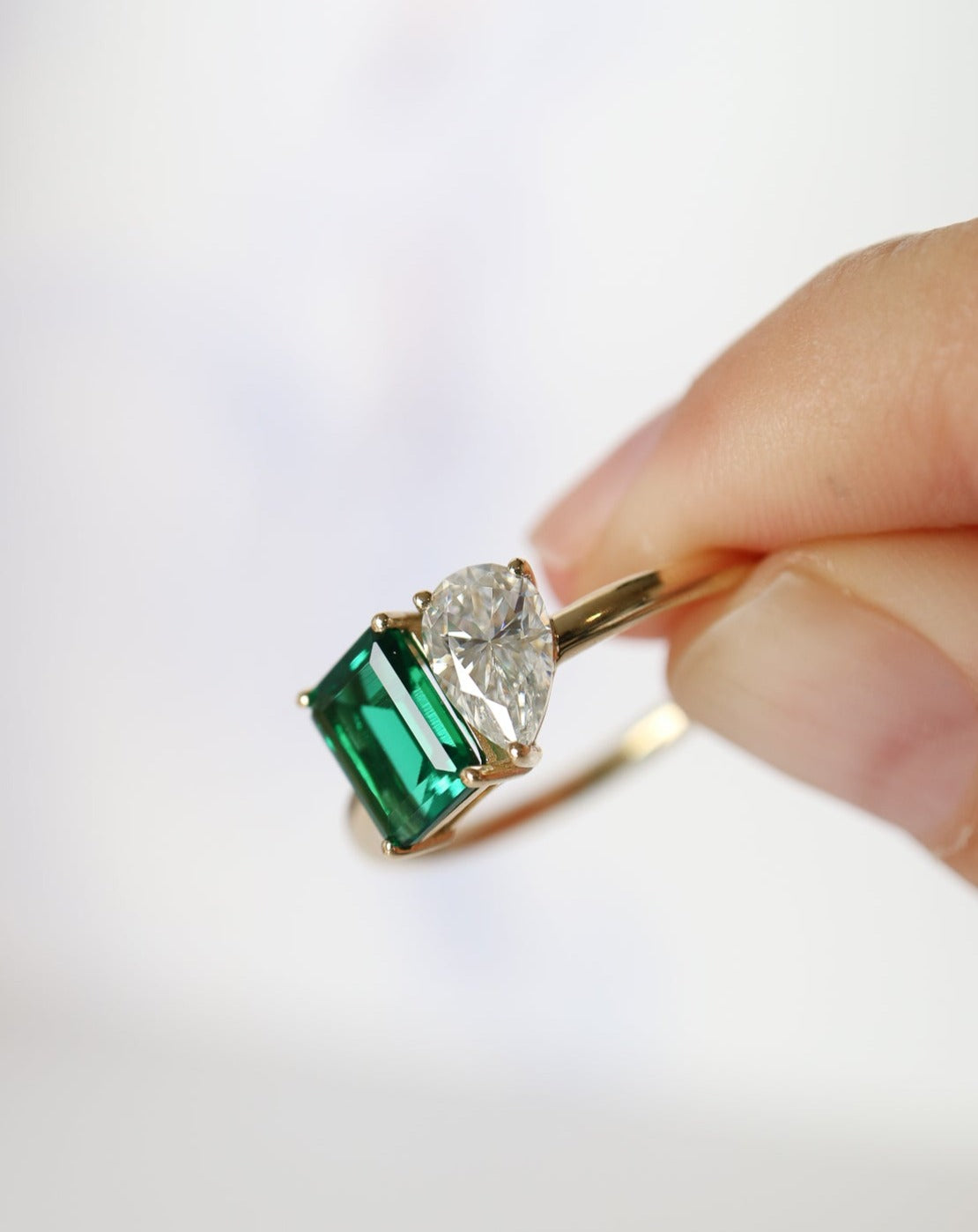 9kt gold Venus Ring with pear moissanite and emerald baguette from Theia Jewellery engagement rings