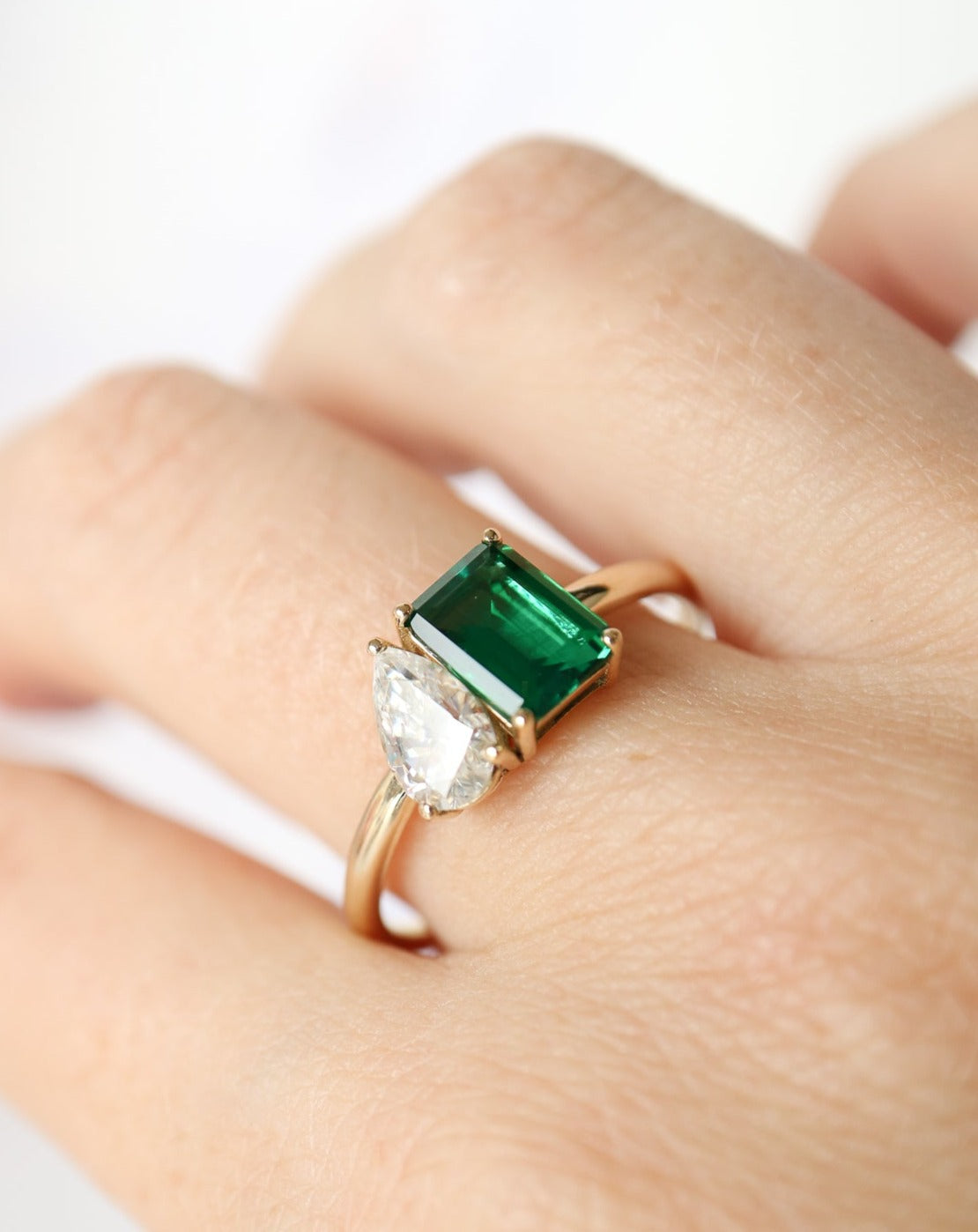 9kt gold Venus Ring with pear moissanite and emerald baguette from Theia Jewellery engagement rings