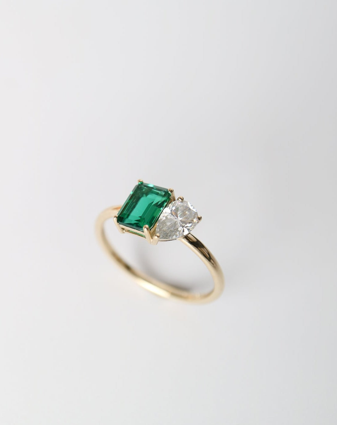 9kt gold Venus Ring with pear moissanite and emerald baguette from Theia Jewellery engagement rings