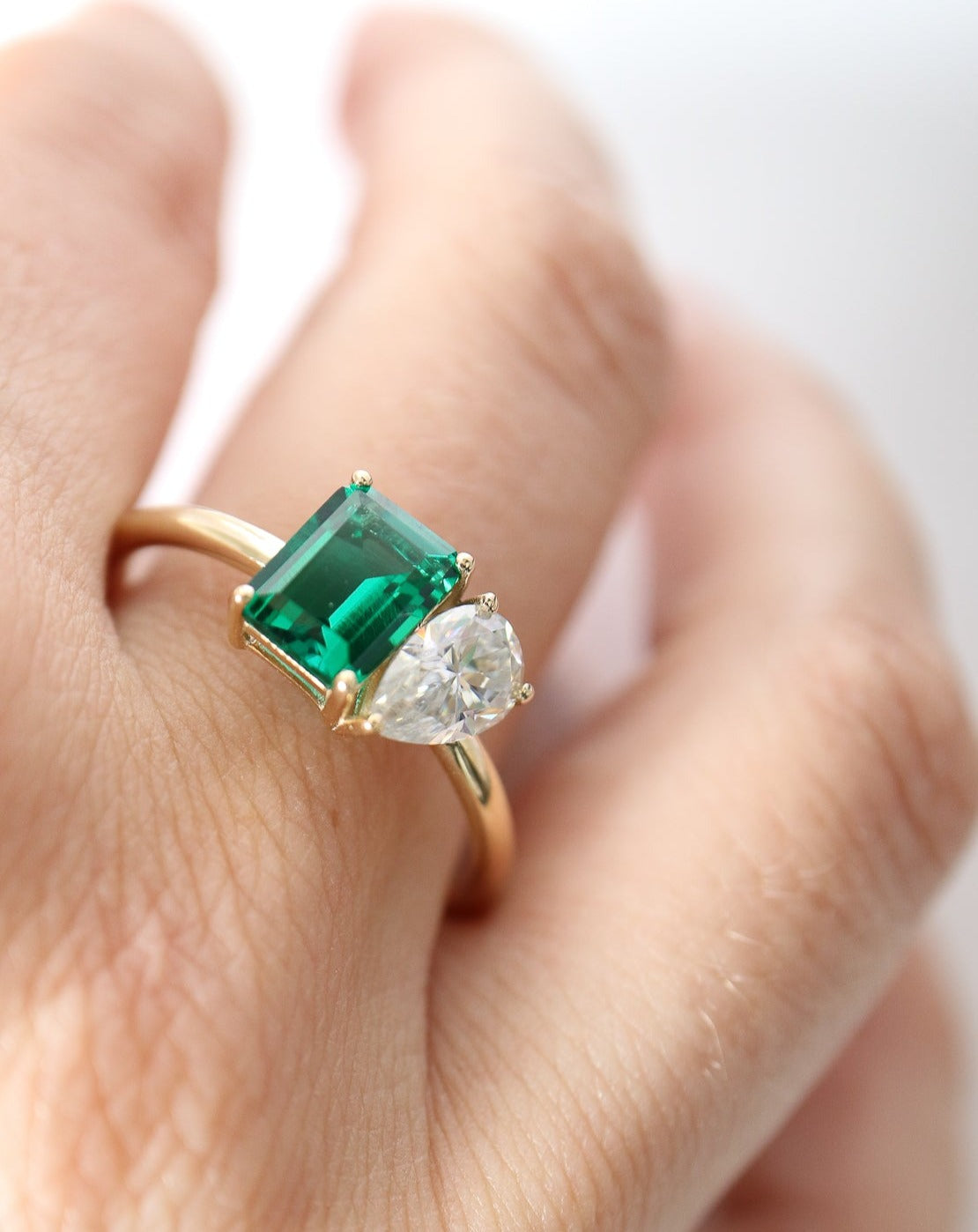 9kt gold Venus Ring with pear moissanite and emerald baguette from Theia Jewellery engagement rings