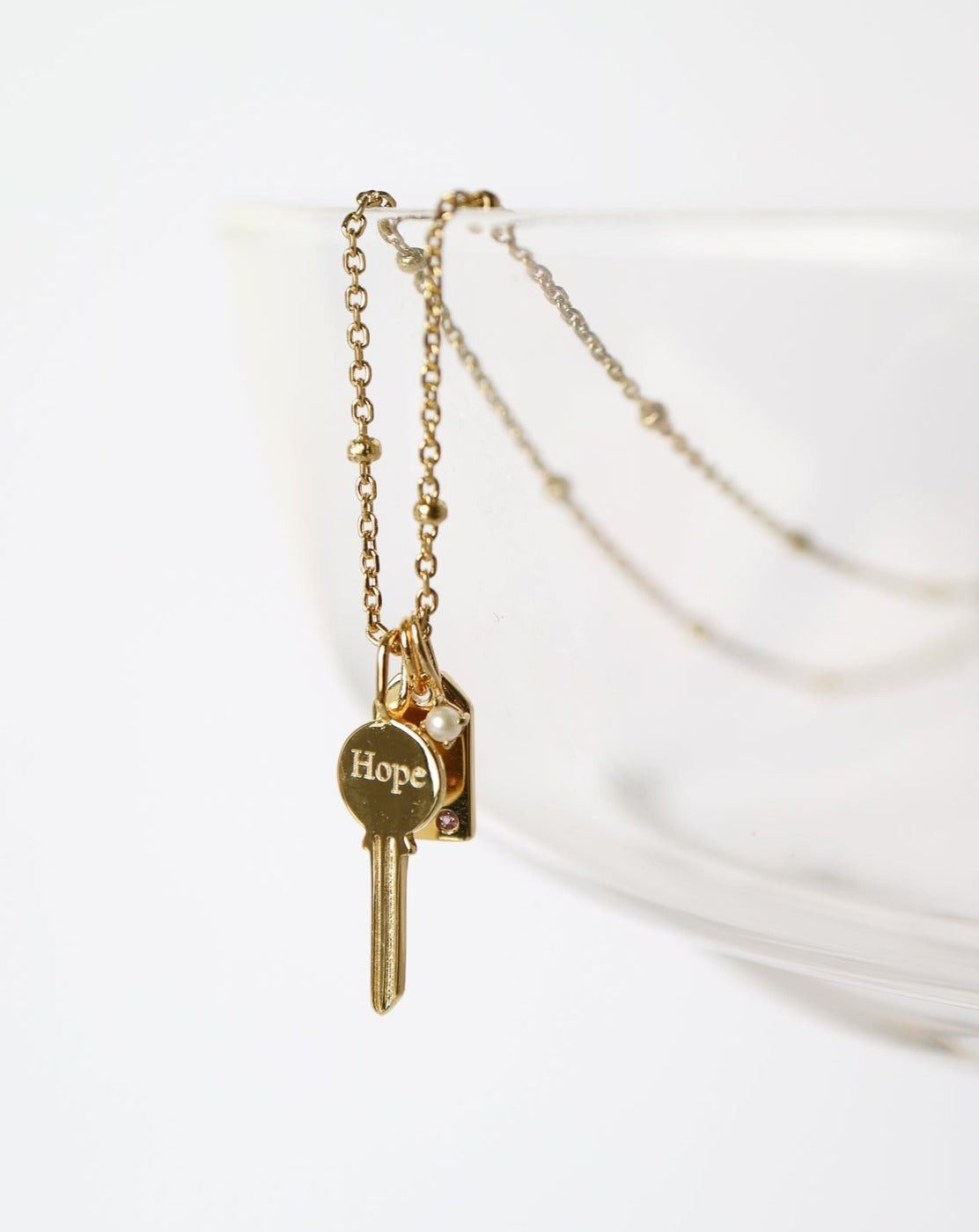 Gold Charm Necklace with key, pearl, gemstone tag