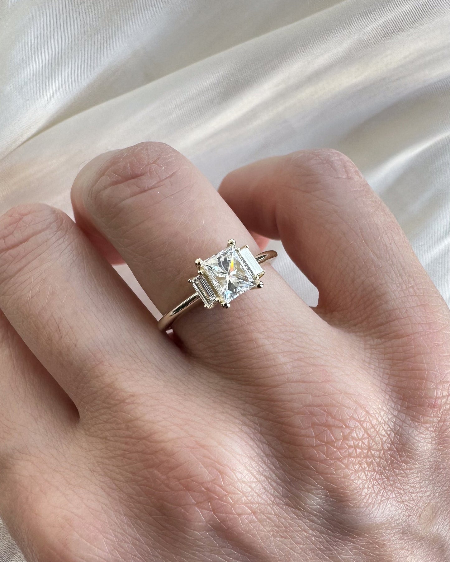Diamond ring on a hand with a soft white background