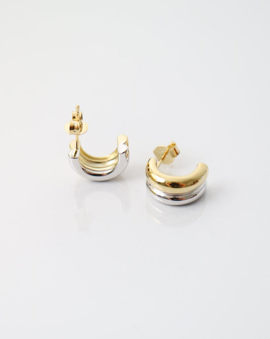 Interlude Hoops featuring a sculptural mixed-metal design with polished gold plated and sterling silver bands and butterfly back fastenings.