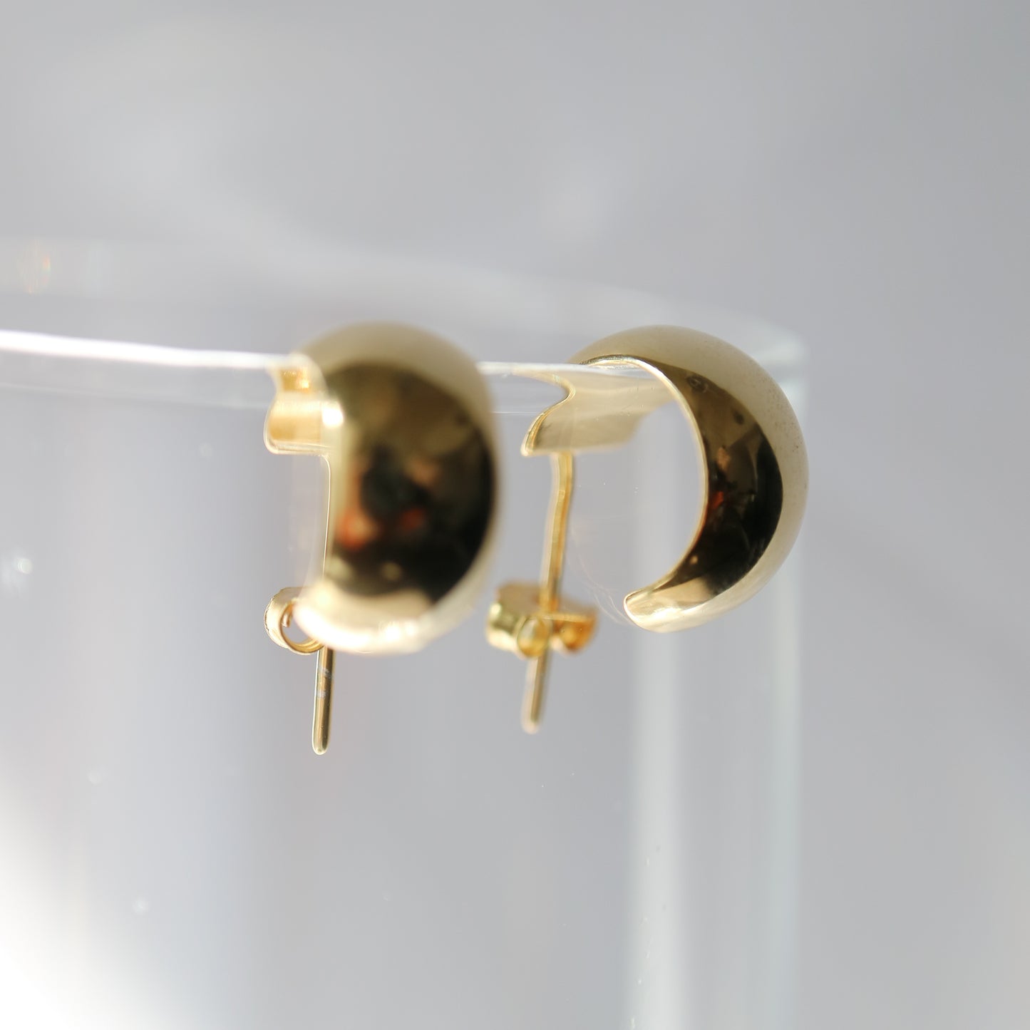 domed wide huggie earrings in gold