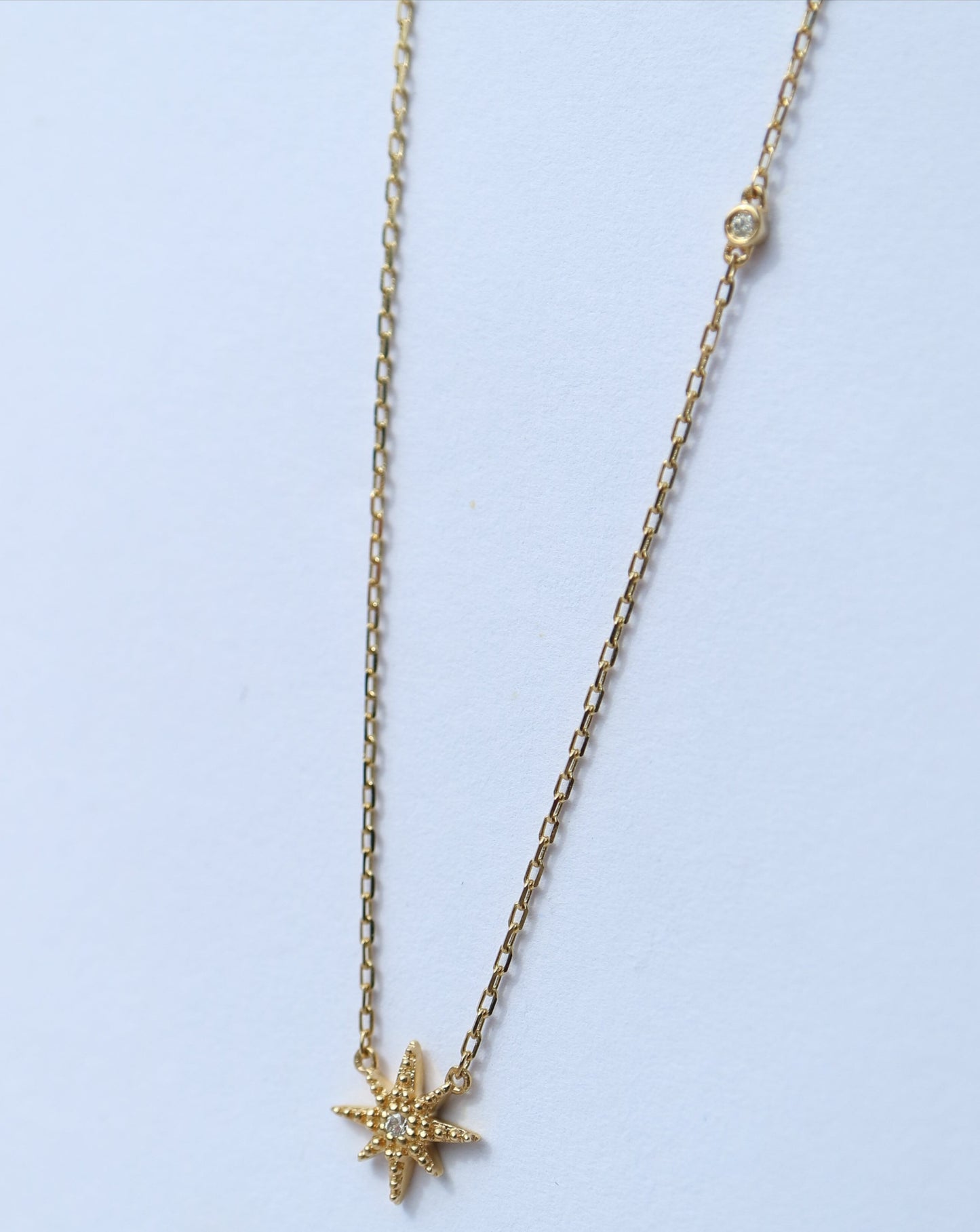 10kt gold and diamond stardust pendant by La Kaiser Jewelry