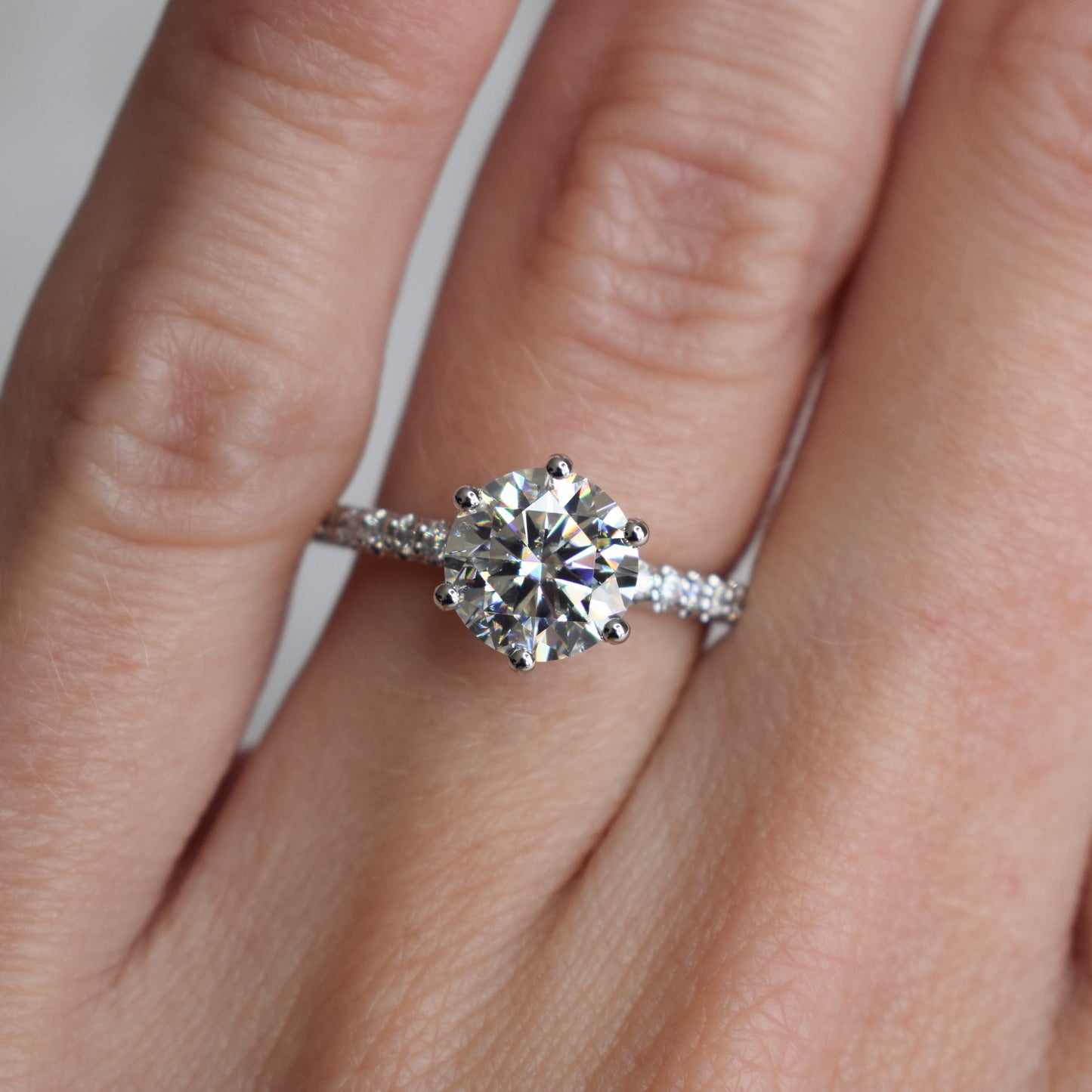 Round brilliant engagement ring with pavé-band