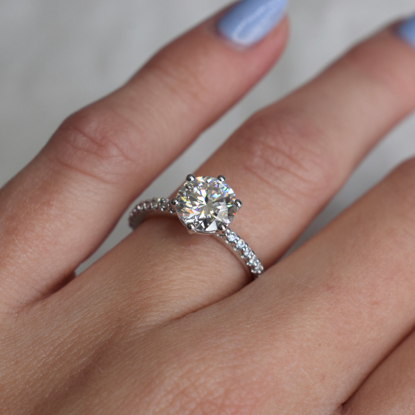 Round brilliant engagement ring with pavé-band