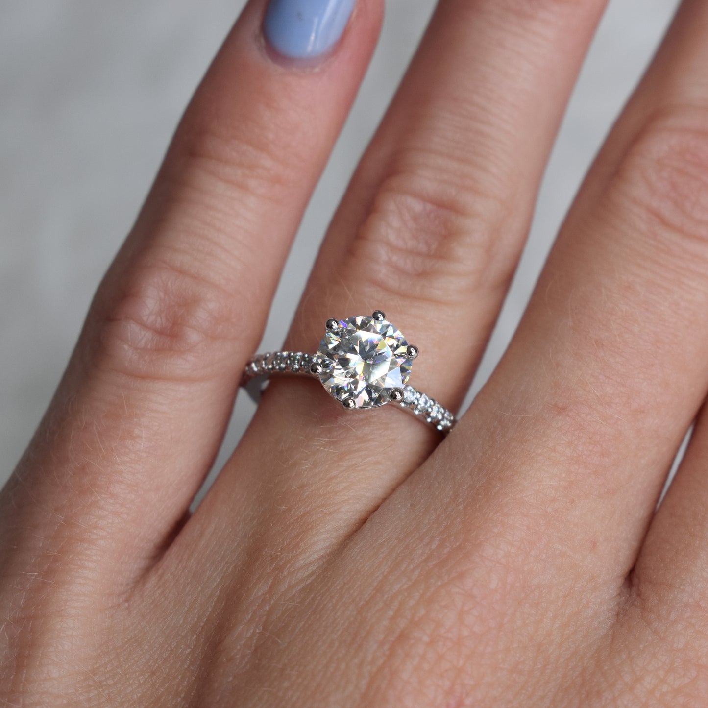 Round brilliant engagement ring with pavé-band