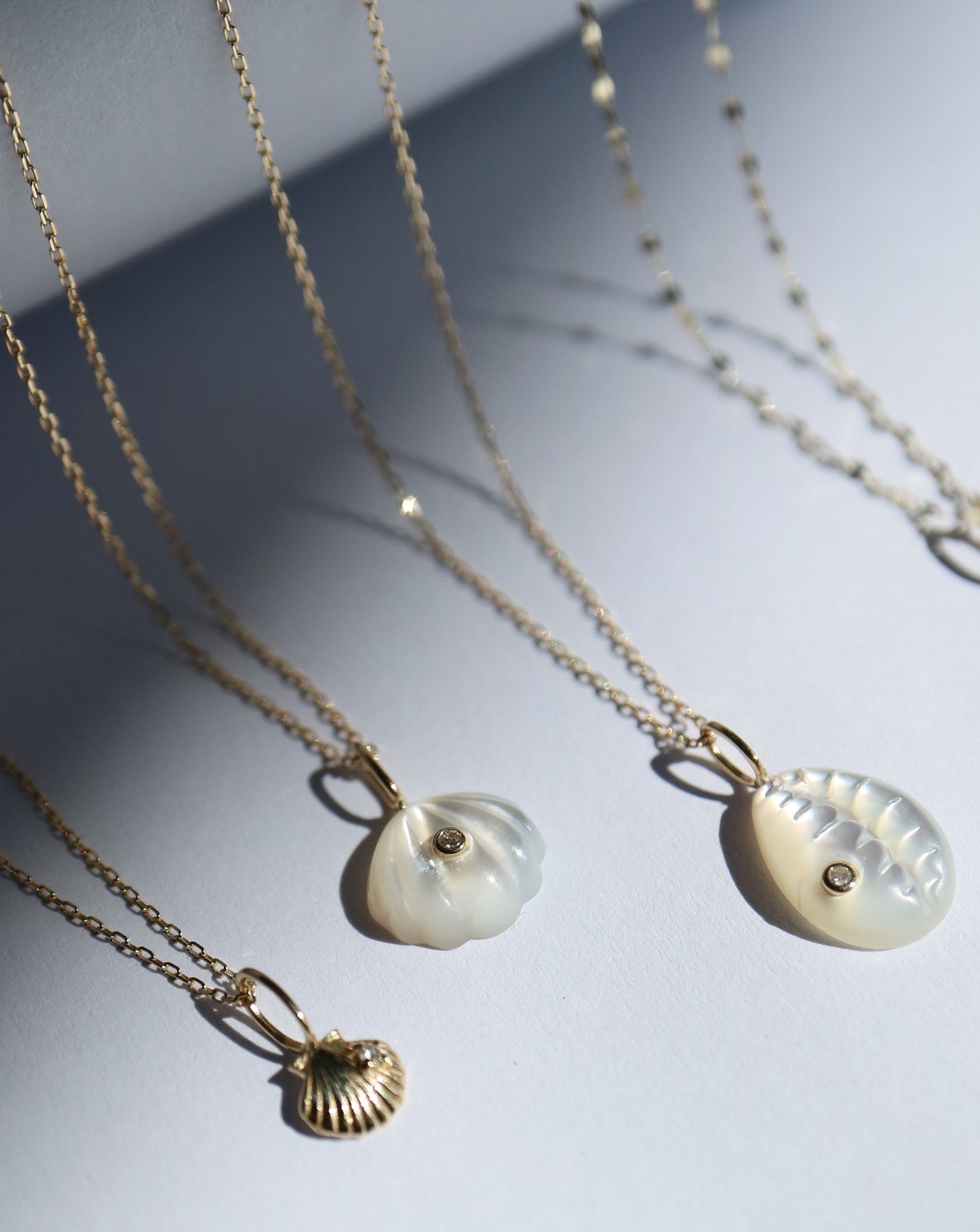 9kt gold and diamond shell pendant