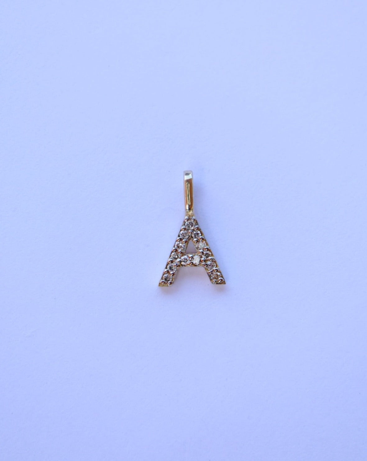 9kt gold and diamond initial pendants by Collective & Co.
