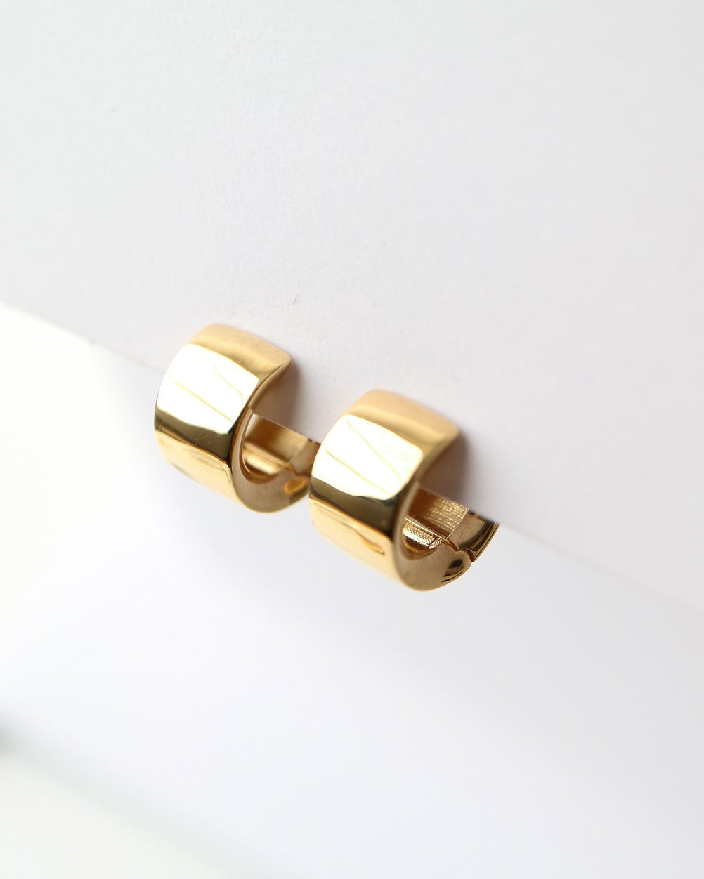 Gold earring on a white background