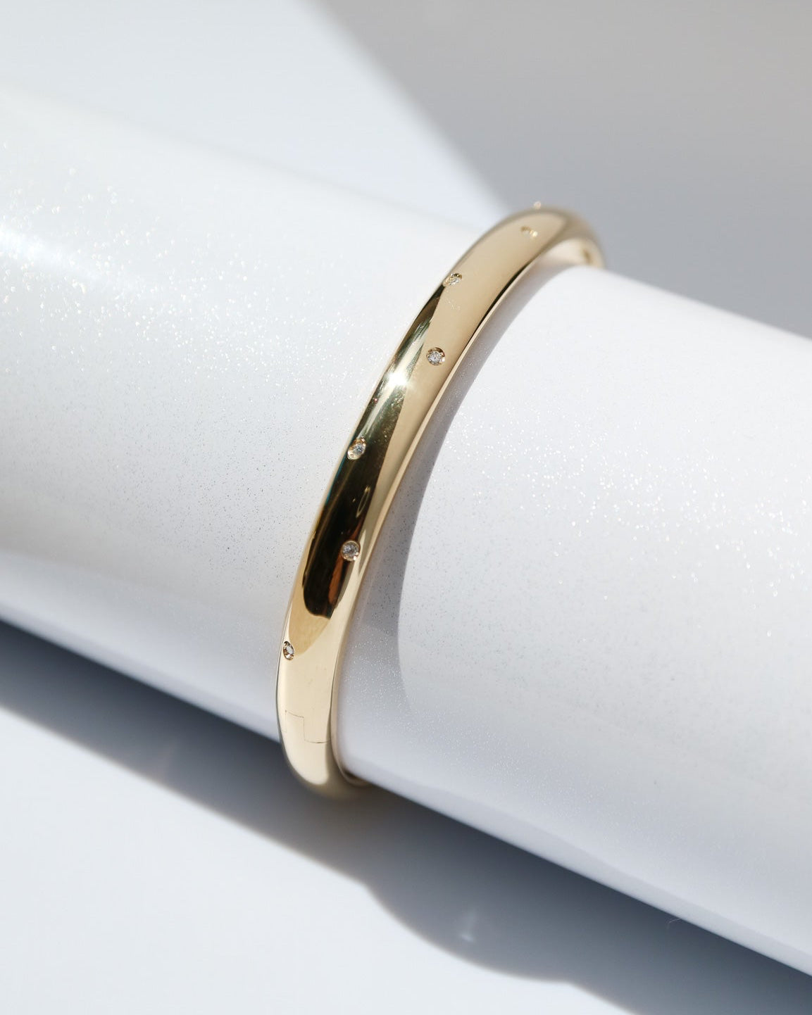 Gold ring on a white cylindrical object