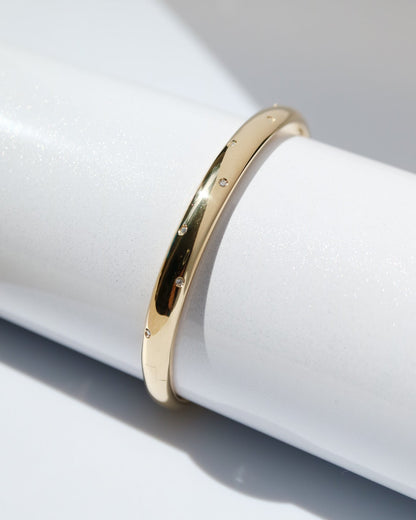 Gold ring on a white cylindrical object