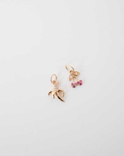 Cherry charm with rubies and gold banana charm with diamonds