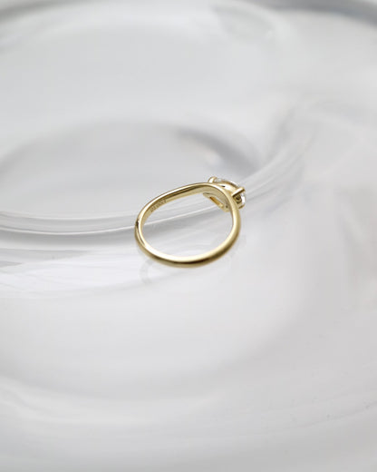 Gold ring on a white plate with a white background