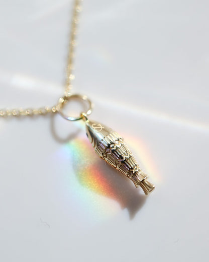 Gold necklace with a pendant on a white background