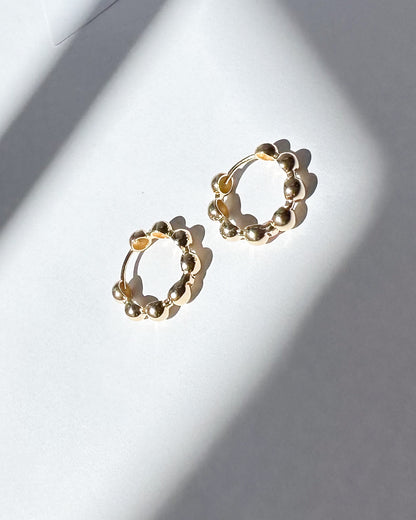 9ct Gold hoop earrings on a light gray background
