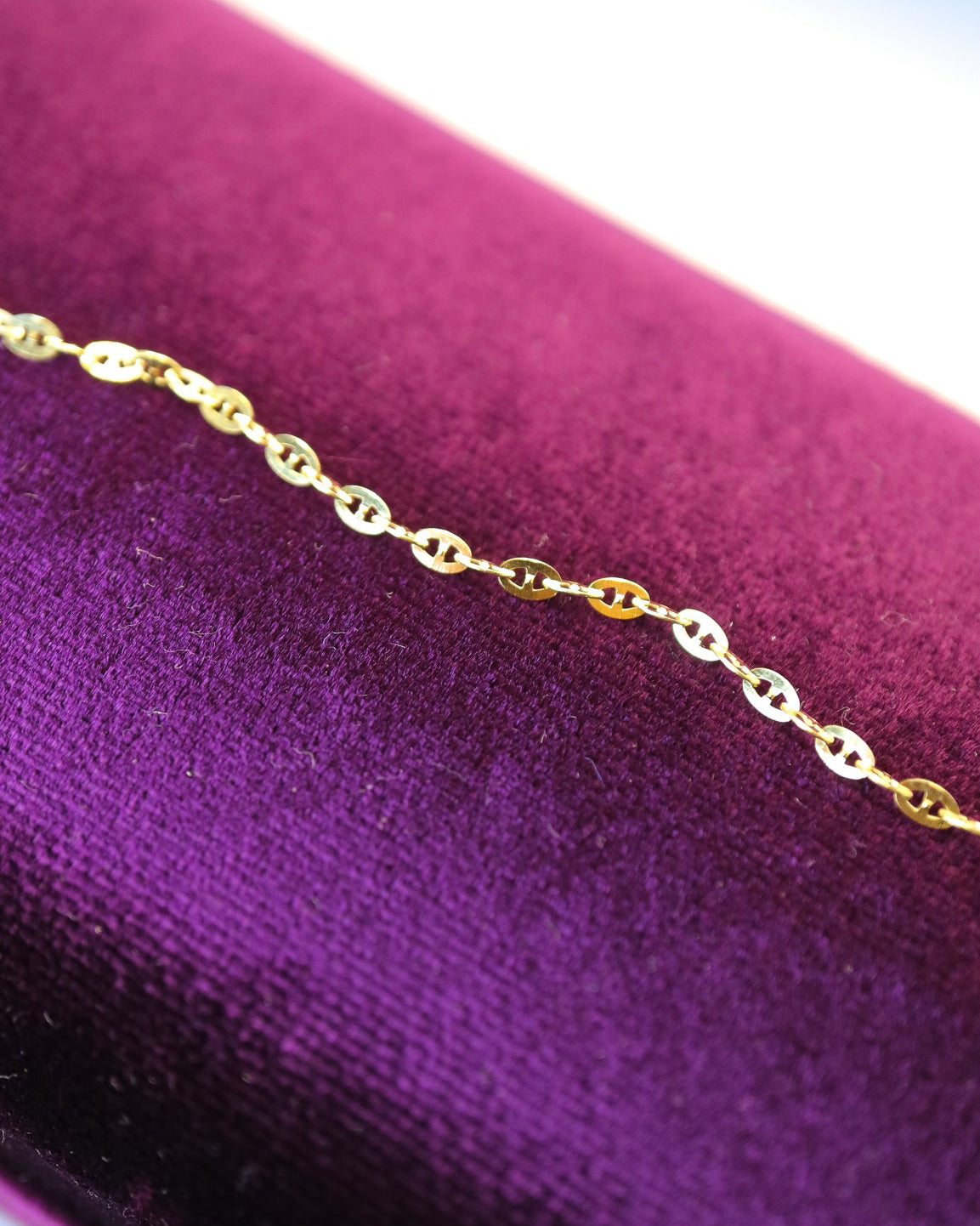 
9ct solid gold Mini Gucci Link Chain necklace on a white background, showcasing its delicate interlocking links and polished gold finish.