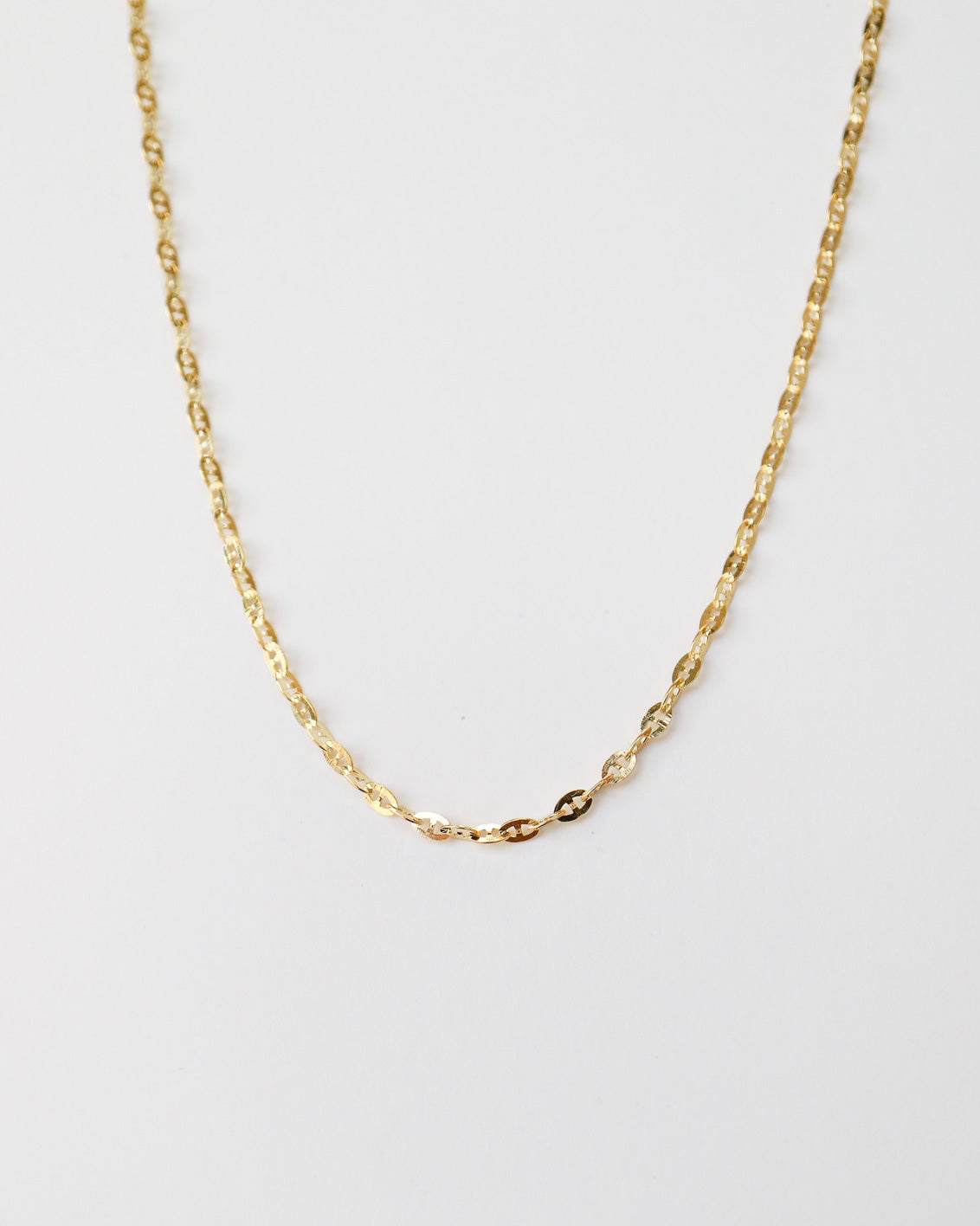 9kt solid gold Mini Gucci Link Chain necklace on a white background, showcasing its delicate interlocking links and polished gold finish.