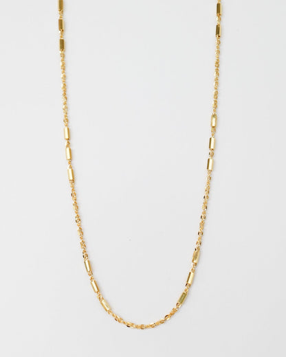 9kt solid gold Morse Code Chain necklace featuring a delicate gold chain with polished rectangular bar accents, photographed on an off-white background.