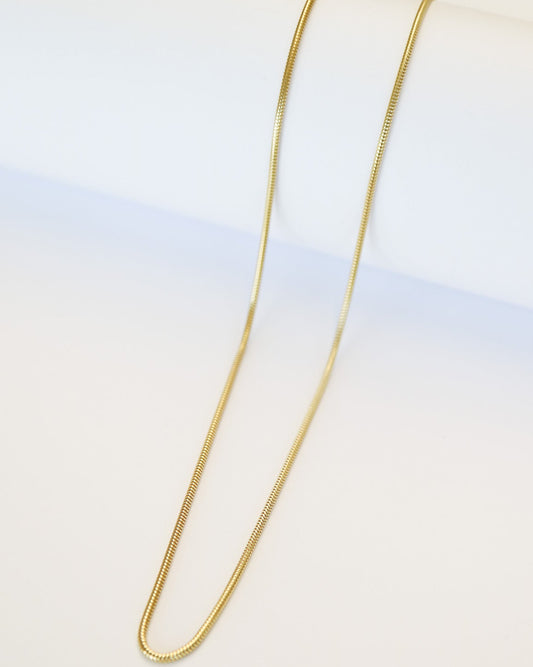 9ct gold Skinny Real Snake Chain over white background