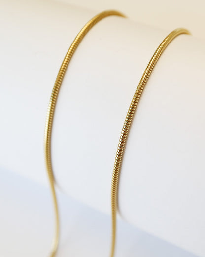 9ct gold Skinny Real Snake Chain over white background