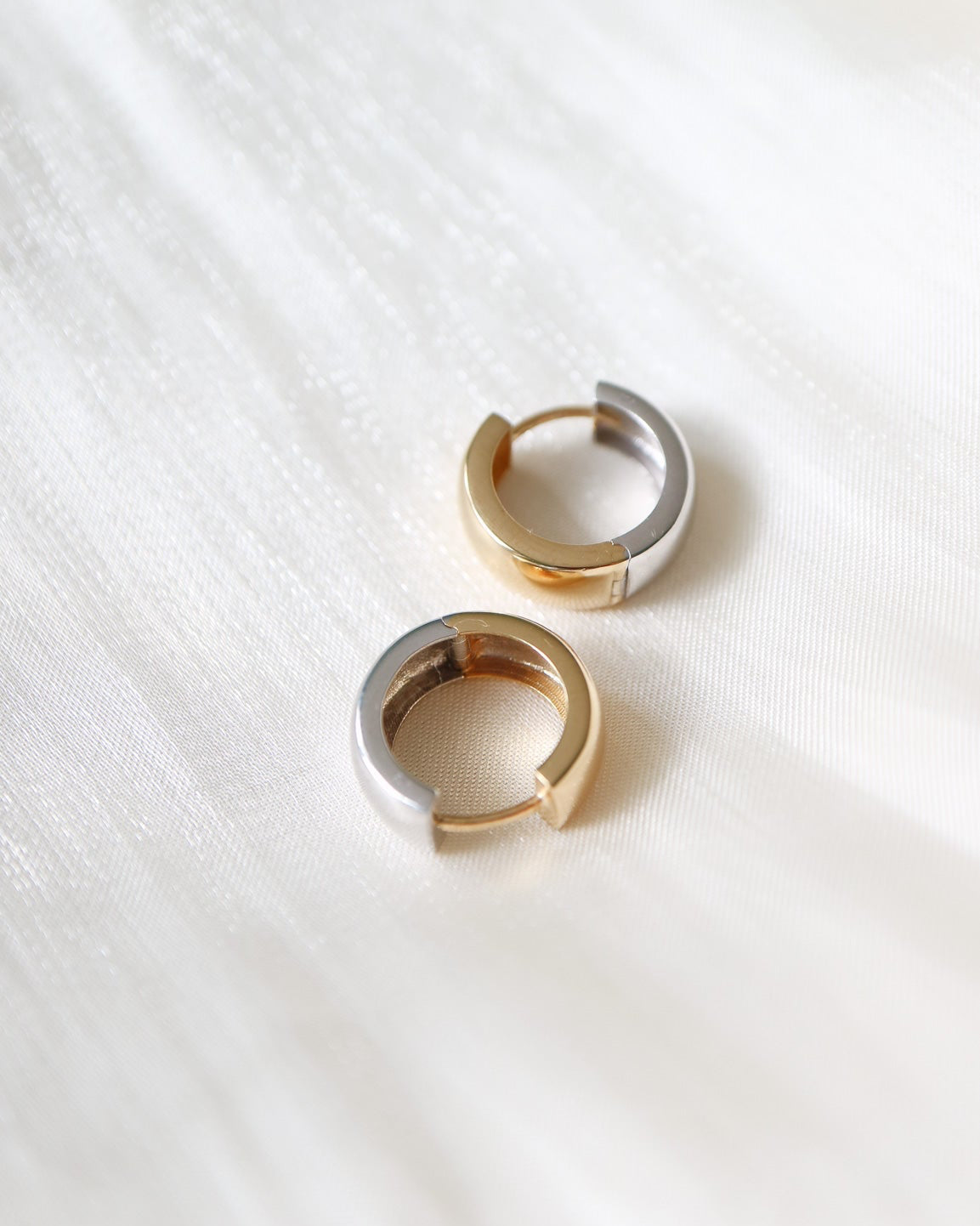 Close-up of 9kt solid gold Two Tone Hoops showcasing their sculptural shape and contrasting gold and silver finishes, perfect for modern everyday styling.