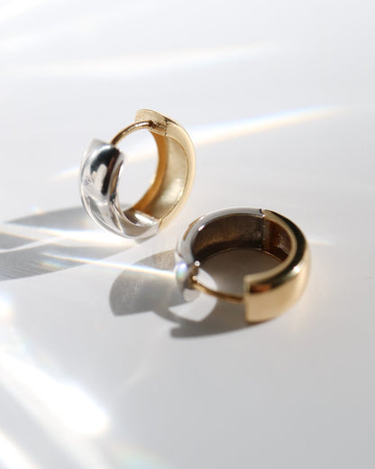 9kt solid gold Two Tone Hoops featuring a contemporary rounded design with contrasting polished gold and silver tones, photographed on a white background with soft sunlight and shadows.