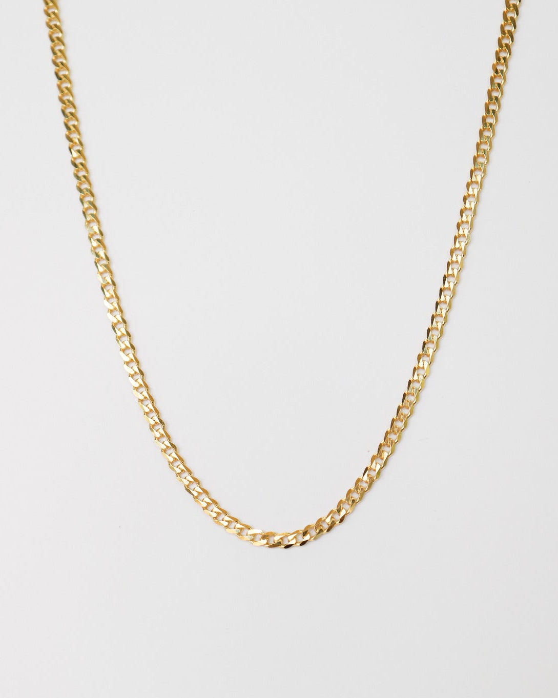 9kt solid gold Flat Curb Chain necklace featuring polished, flattened interlocking links, photographed on a white background.