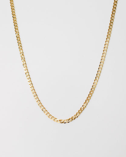 9kt solid gold Flat Curb Chain necklace featuring polished, flattened interlocking links, photographed on a white background.