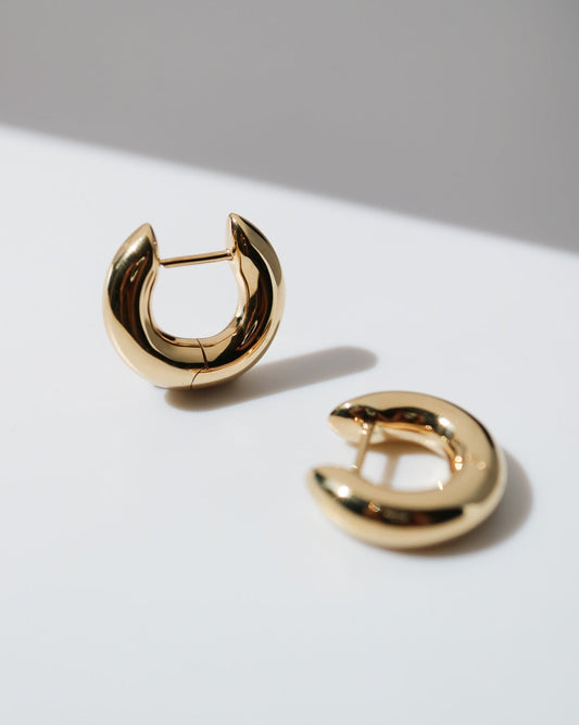 Pair of polished 9ct yellow gold Halo Hoop earrings with a rounded sculptural design and hinged fastening.