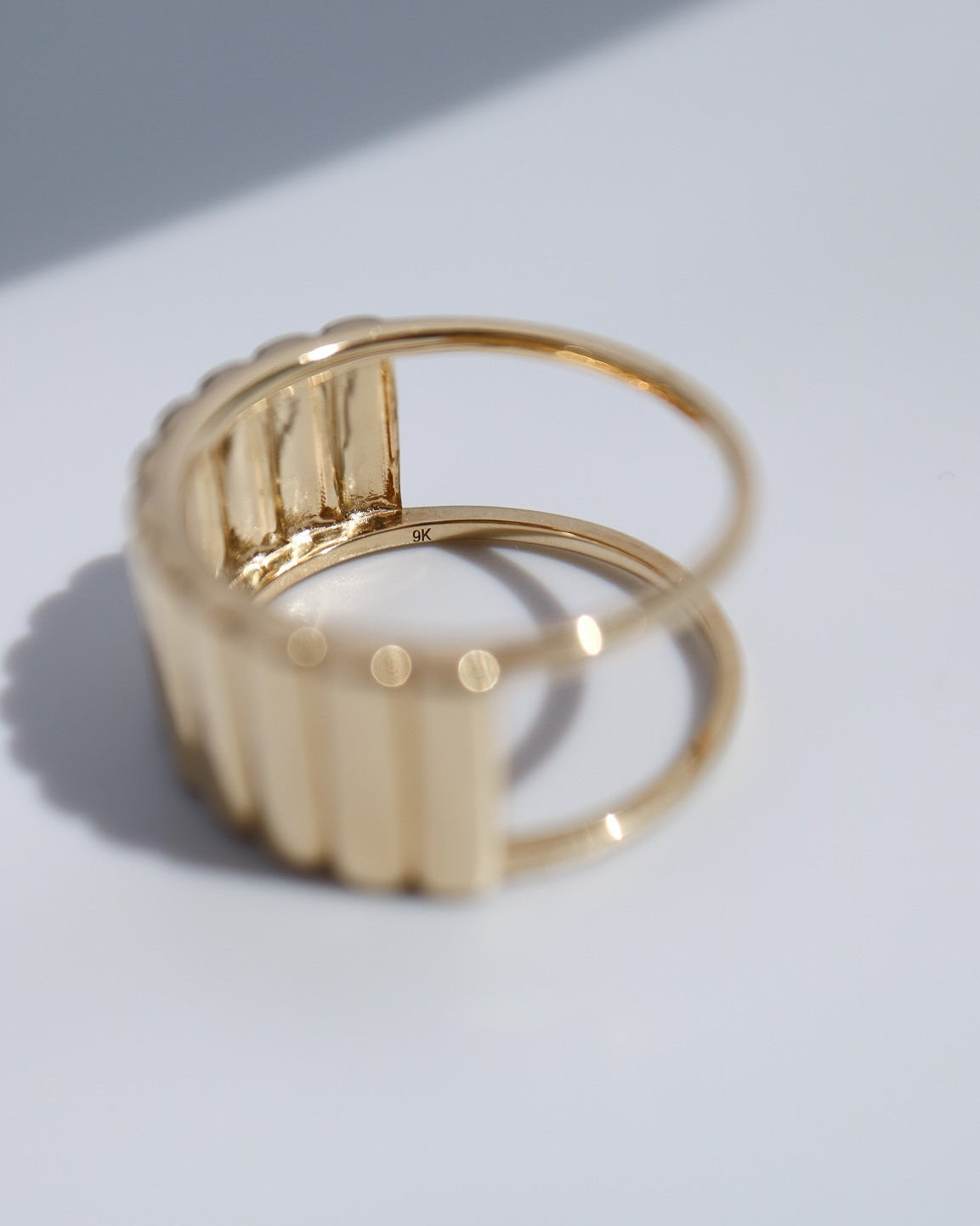 Side profile of the 9kt gold Oura Ring jacket showing its sculptural design.