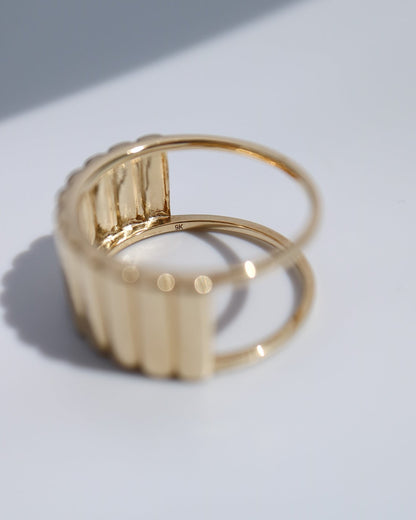 Side profile of the 9kt gold Oura Ring jacket showing its sculptural design.