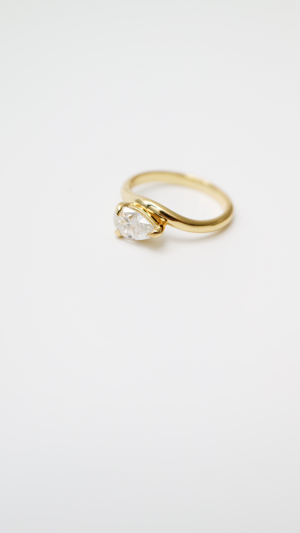 Gold ring with a diamond on a white background