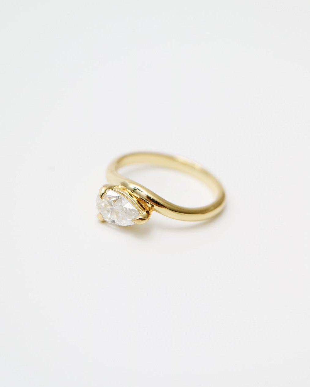 Gold ring with a diamond on a white background