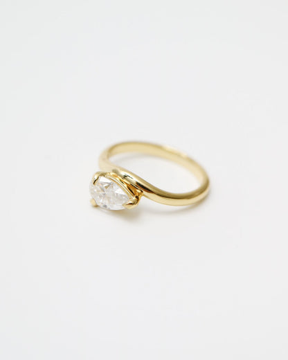 Gold ring with a diamond on a white background