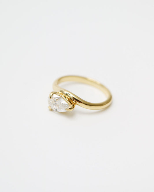 Gold ring with a diamond on a white background