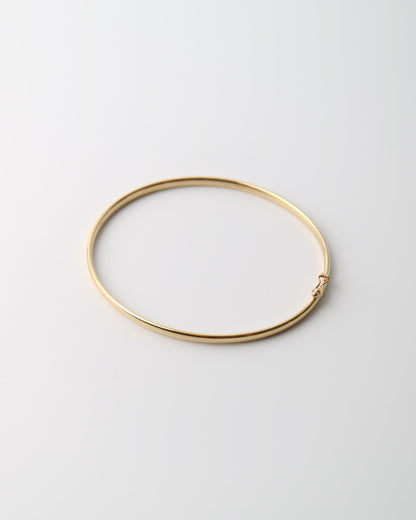 9kt solid gold Classic Oval Bangle with a polished finish, lightweight hollow construction and flexible design, photographed on a white background.