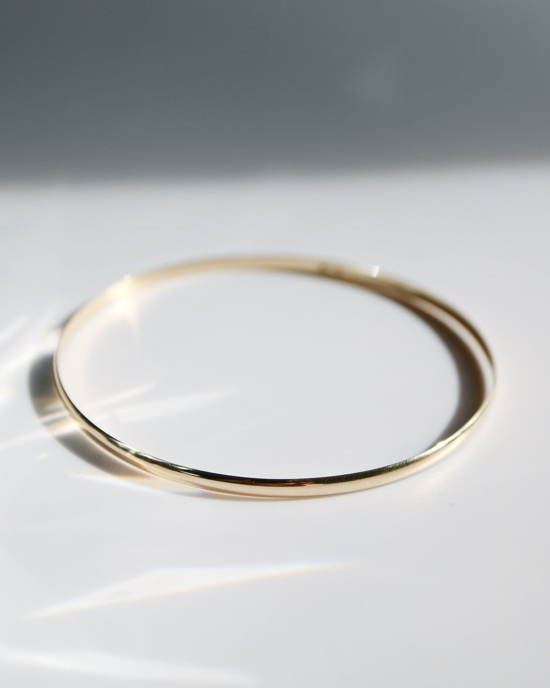 Gold ring on a white surface