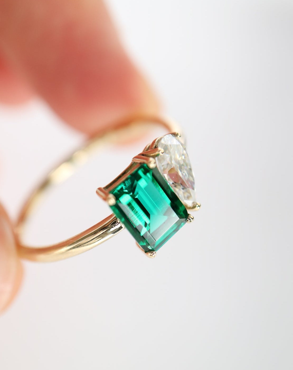 9kt gold Venus Ring with pear moissanite and emerald baguette from Theia Jewellery engagement rings