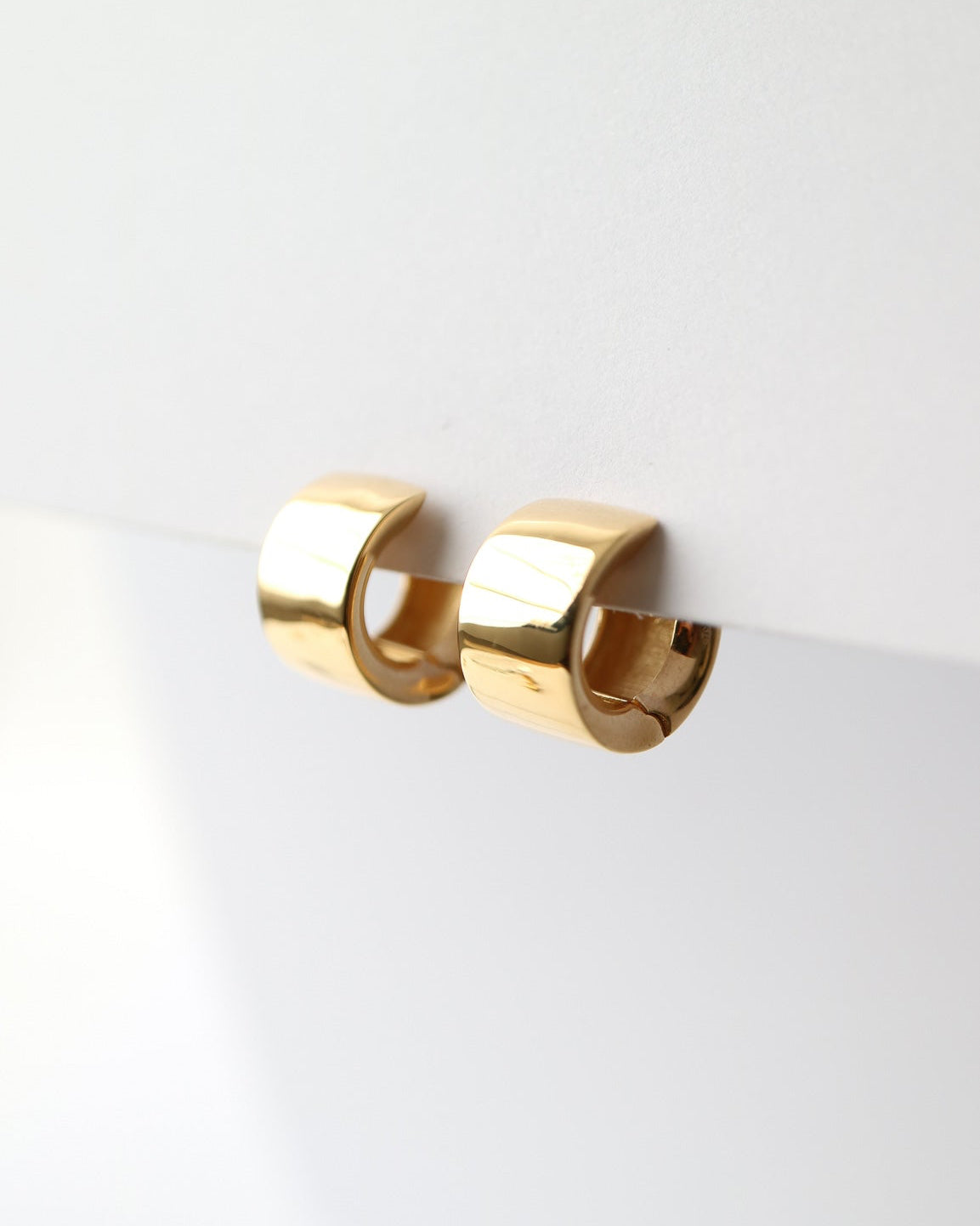 Gold hoop earrings on a white background
