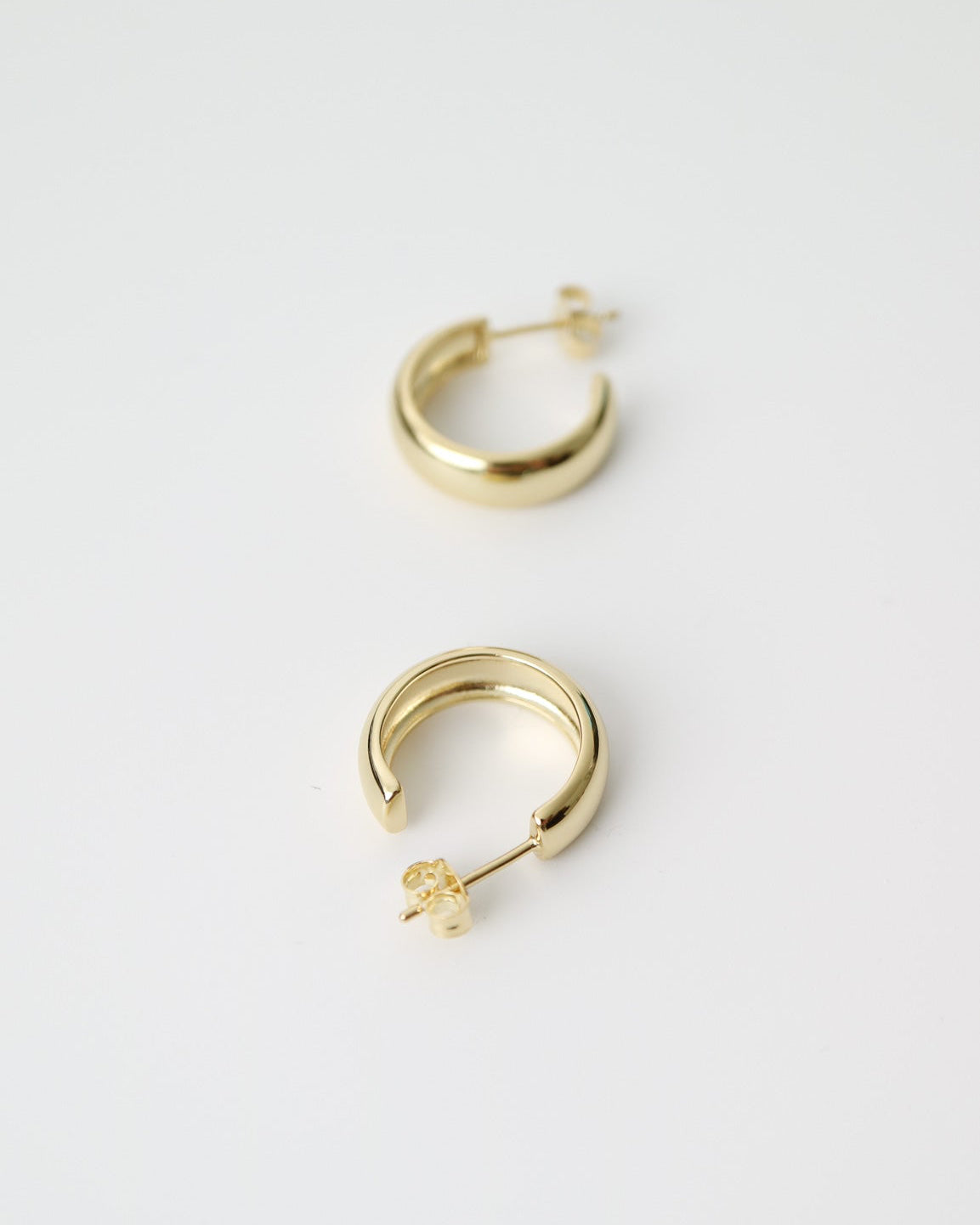Aurelia Hoops in 14kt gold plated sterling silver featuring a polished rounded hoop design with butterfly back fastenings.