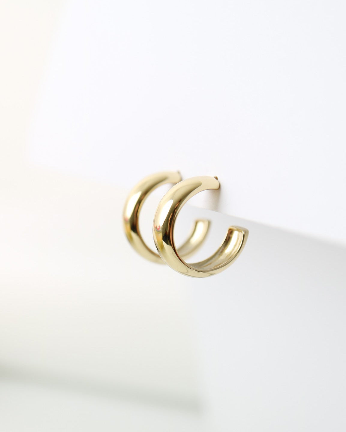 Aurelia Hoops in 14kt gold plated sterling silver featuring a polished rounded hoop design with butterfly back fastenings.