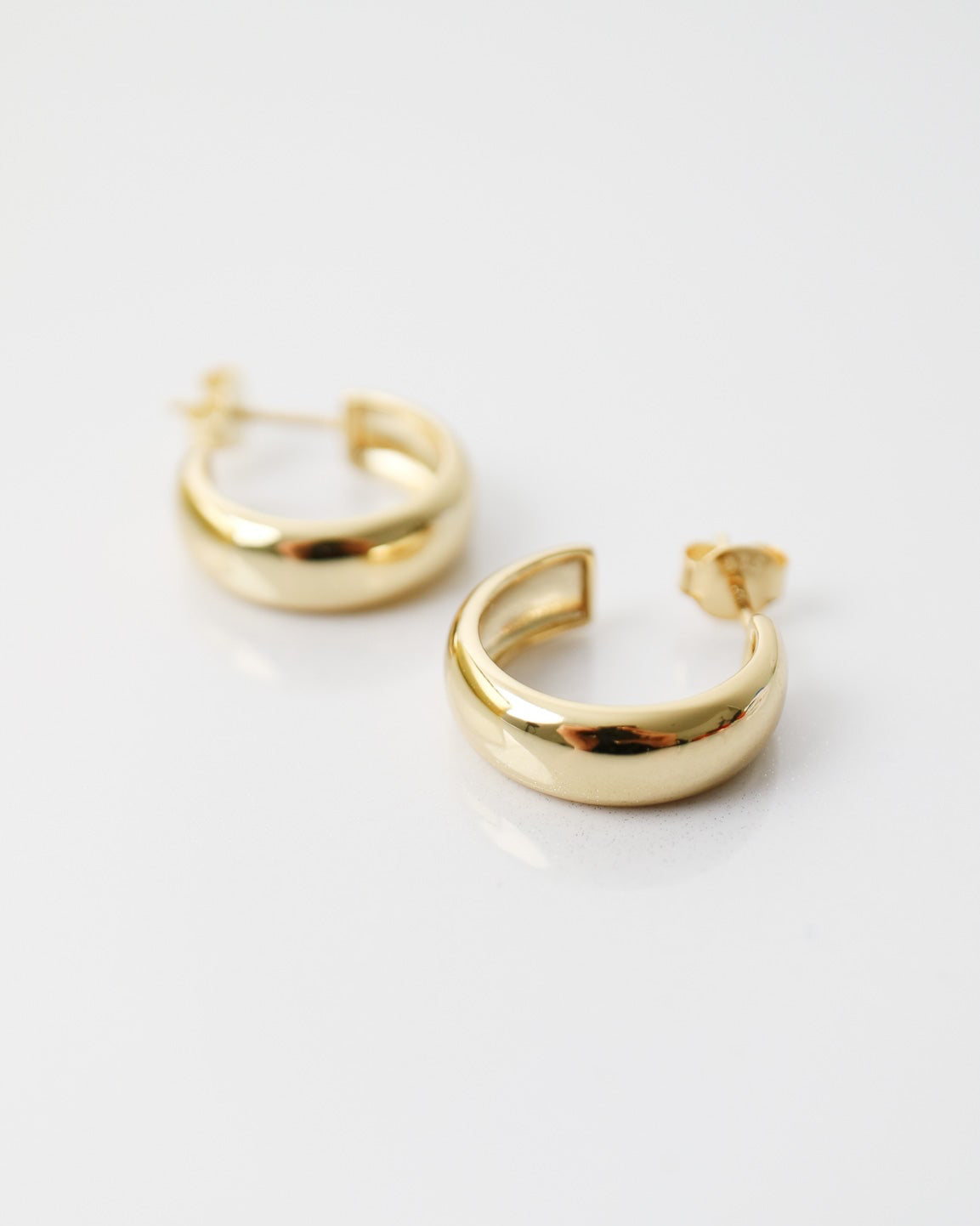 Aurelia Hoops in 14kt gold plated sterling silver featuring a polished rounded hoop design with butterfly back fastenings.