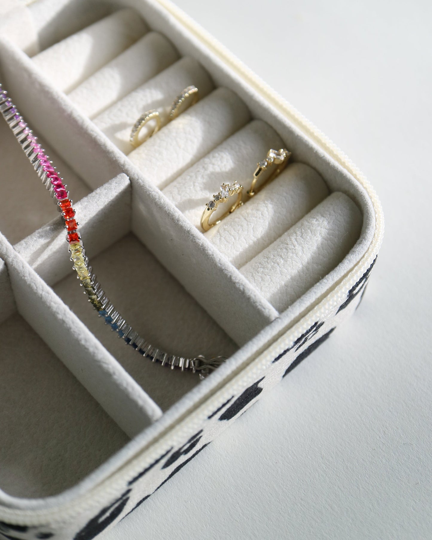 Jewelry box with rings and bracelets on a light gray background