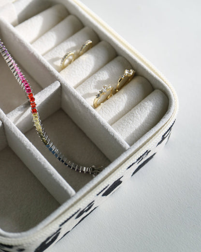 Jewelry box with rings and bracelets on a light gray background