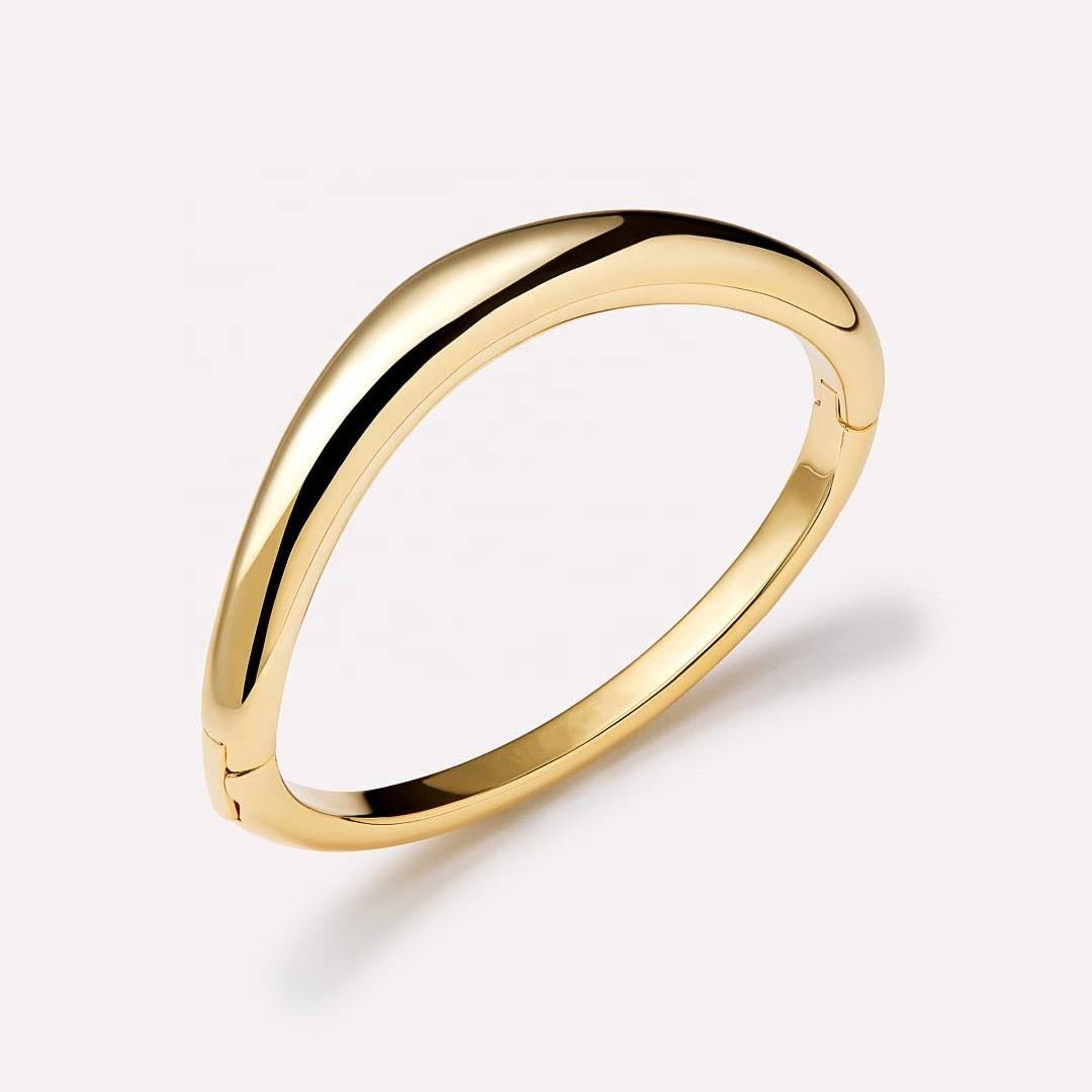 A timeless gold bangle with a modern edge, designed for everyday luxury.