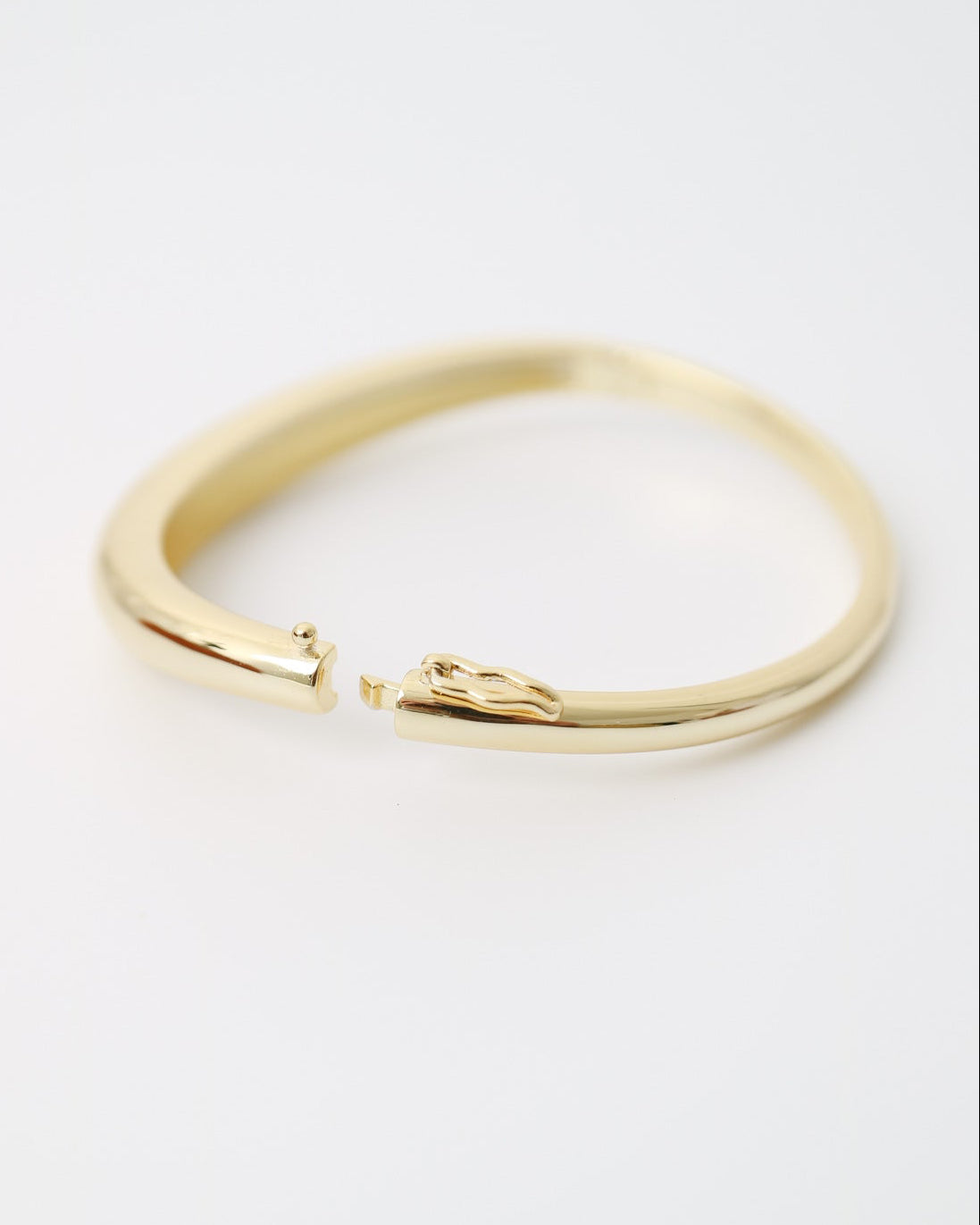 Gold bracelet on a white background